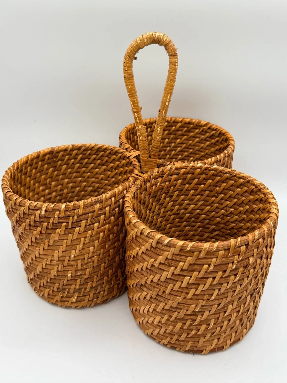 Vintage three-compartment woven rattan caddy/basket with a central loop handle